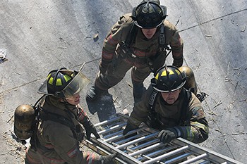 Fire students working with ladder